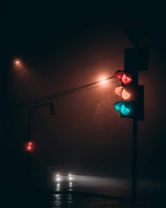 Ampel im Nebel mutheranfahrendem Auto
