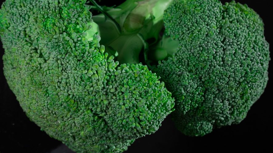 Photo by Mikhail Nilov Vertical shot of vibrant green broccoli florets showcasing natural texture and pattern.
